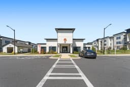Main entrance, leasing office, and mail center at a Pointe Grand community