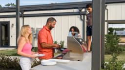 Residents grilling out at a Pointe Grand community