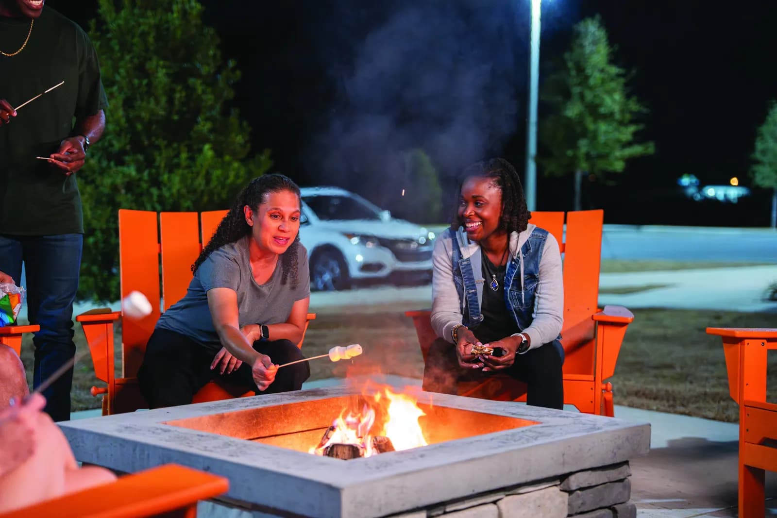 Neighbors gathered around the community fire pit in the evening