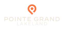 Orange location pin icon above the text “POINTE GRAND LAKELAND” on a light background.